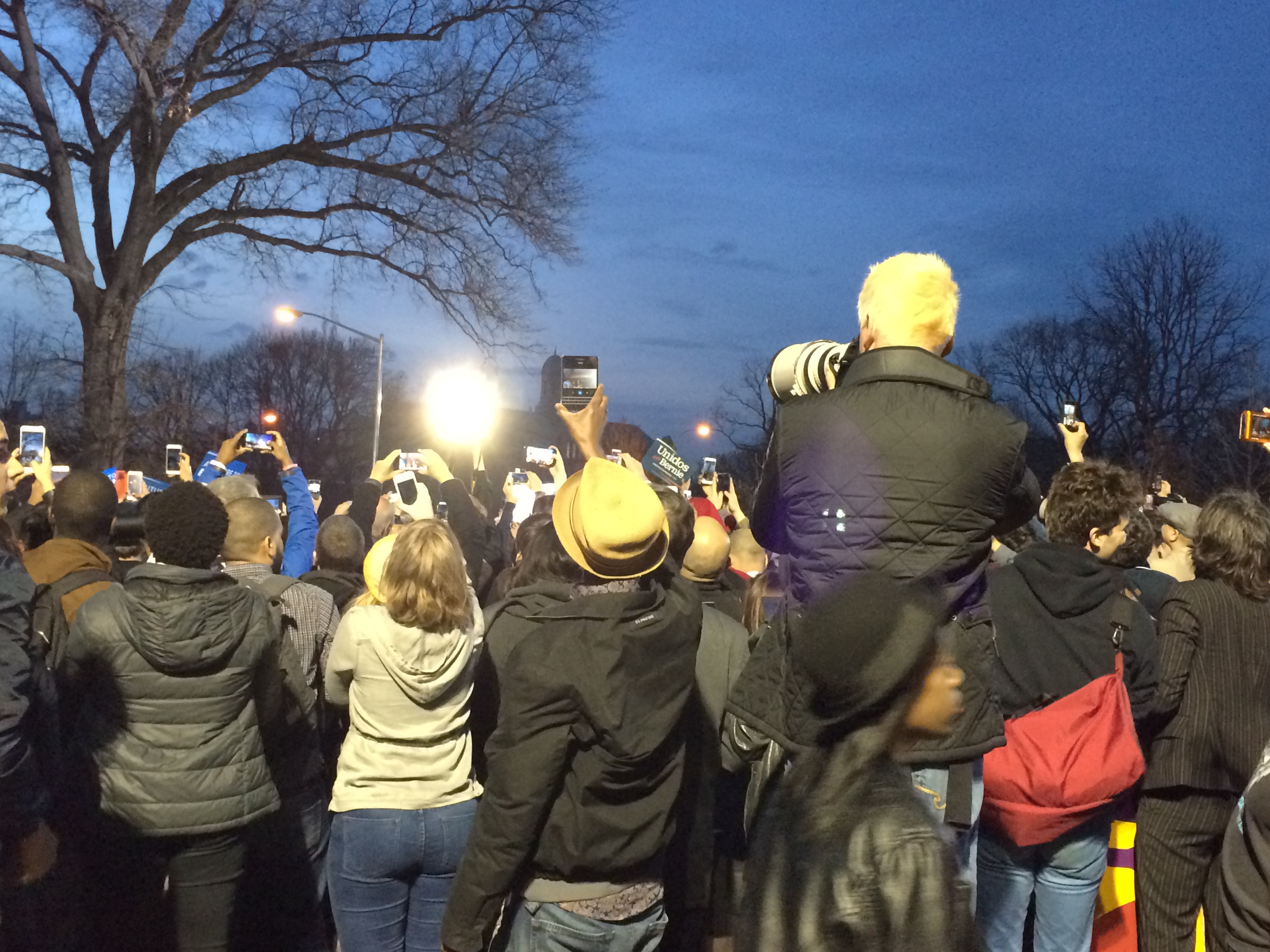 Supporters standing on chairs and hanging onto gates to snap a picture of Bernie Sanders as he took the stage - Photo by Jacob Kornbluh